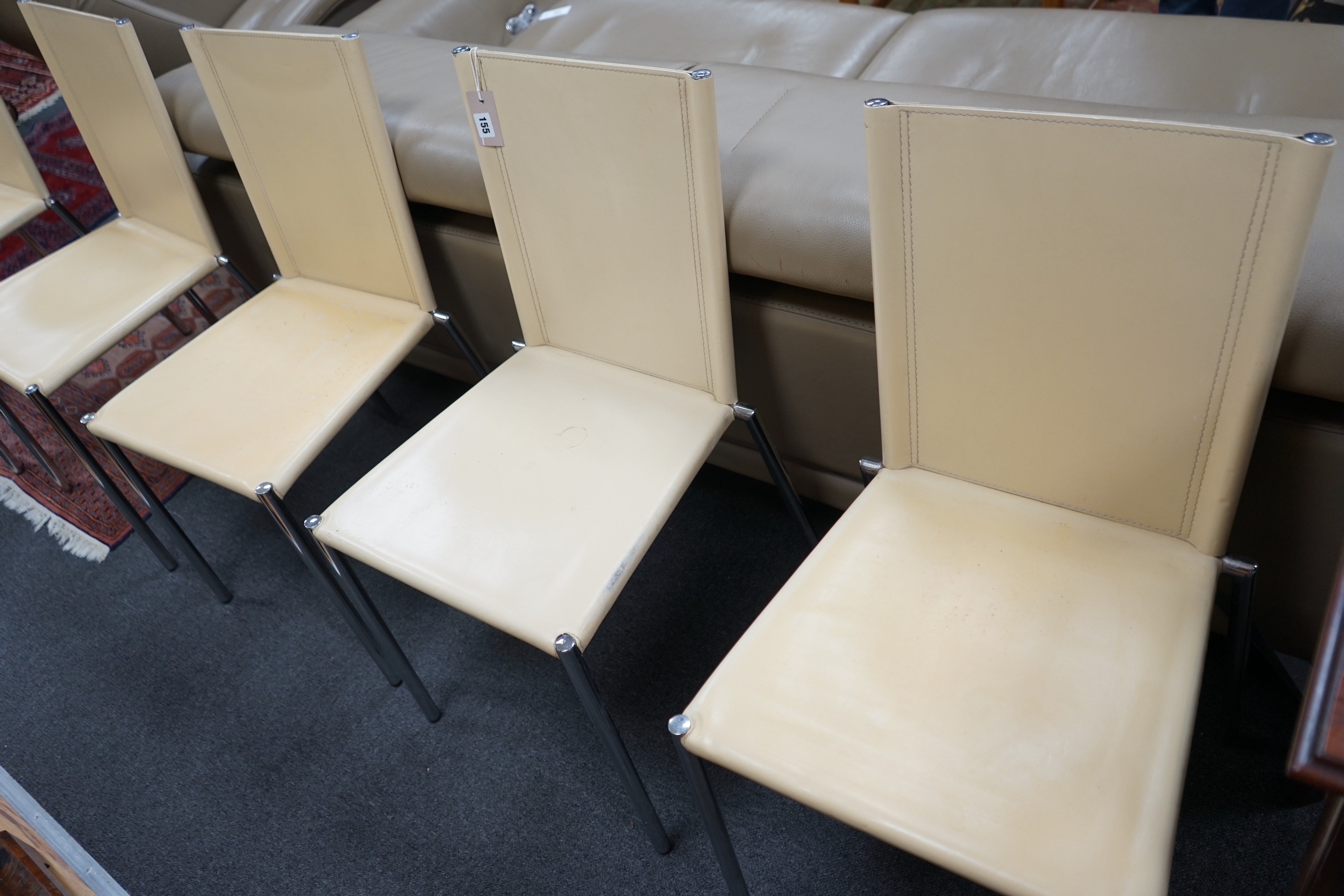 A set of five Italian cream leather and chrome dining chairs